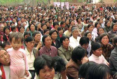 a crowd awaiting Bible distribution
