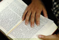 hands with Bible